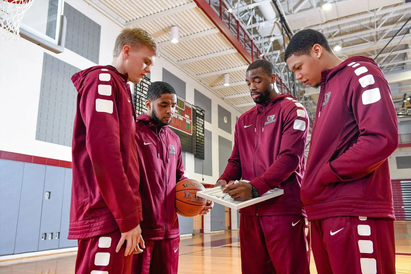 Thaddeus Stevens College basketball coach goes over plays with team members.
