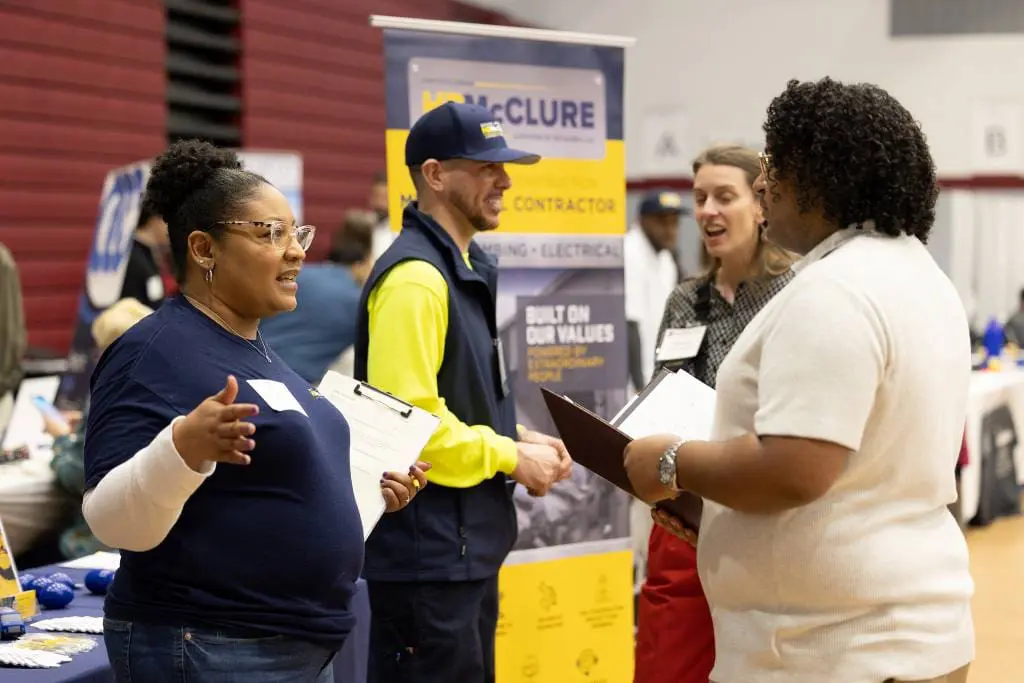 Employers talk with students at a Career Fair. 