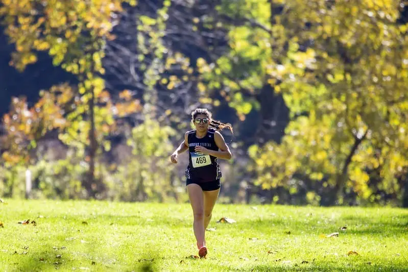 A cross country runner during a race. 
