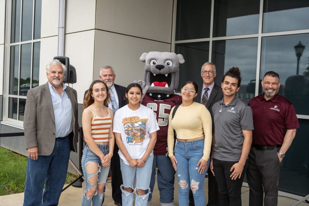 A group of students, leadership, and Champ the mascot at an event. 