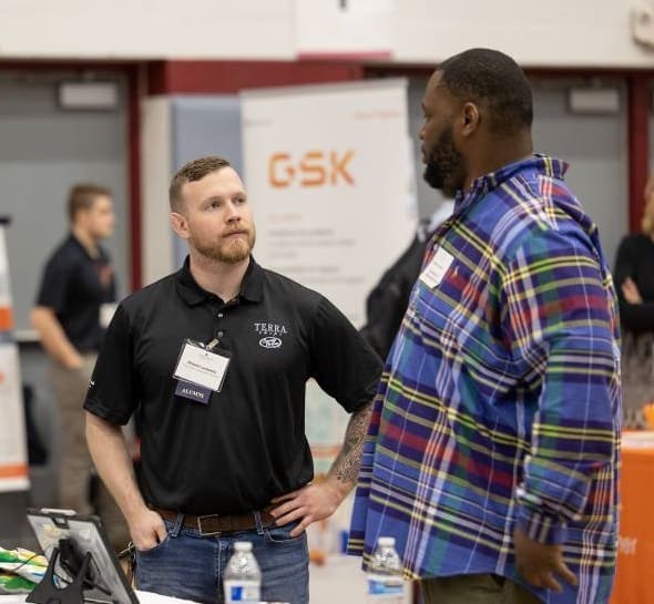 A student speaks with a hiring manager at a Career Fair. 