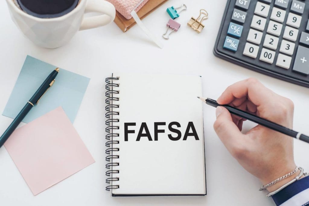 FAFSA Notebook, calculator, and sticky notes