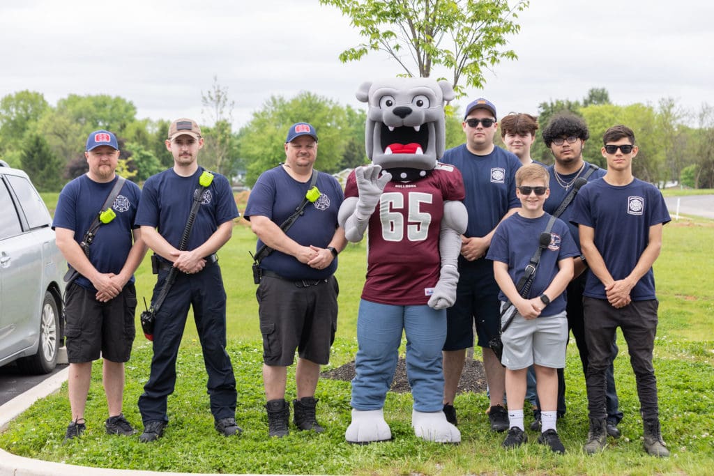 Champ with local volunteer firefighters at a College event. 