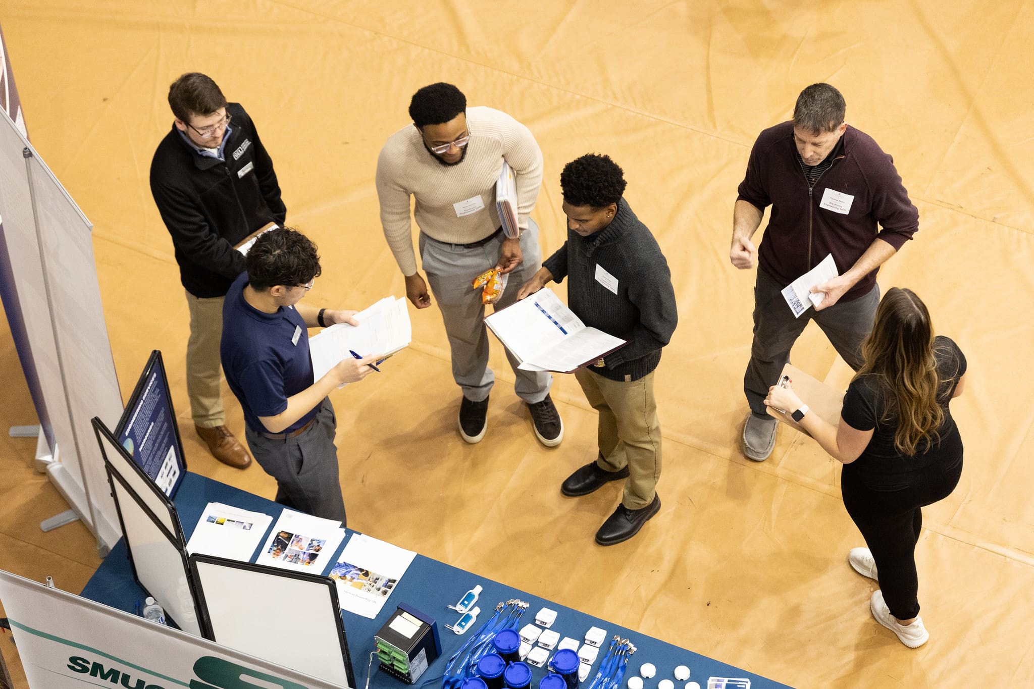 Students speak with employers at career fairs. 