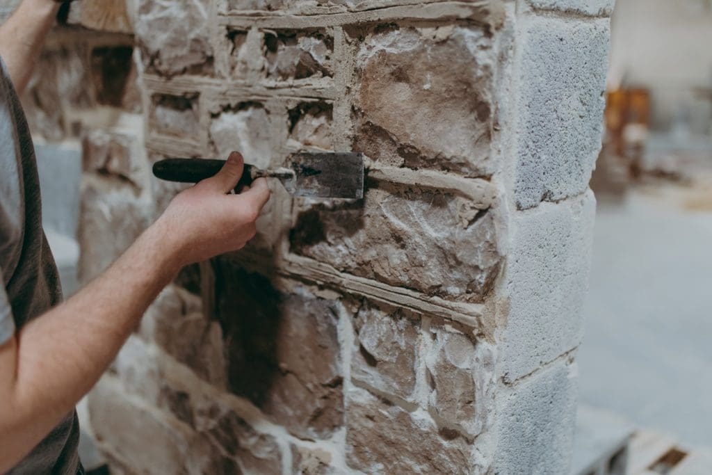 A mason works with bricks
