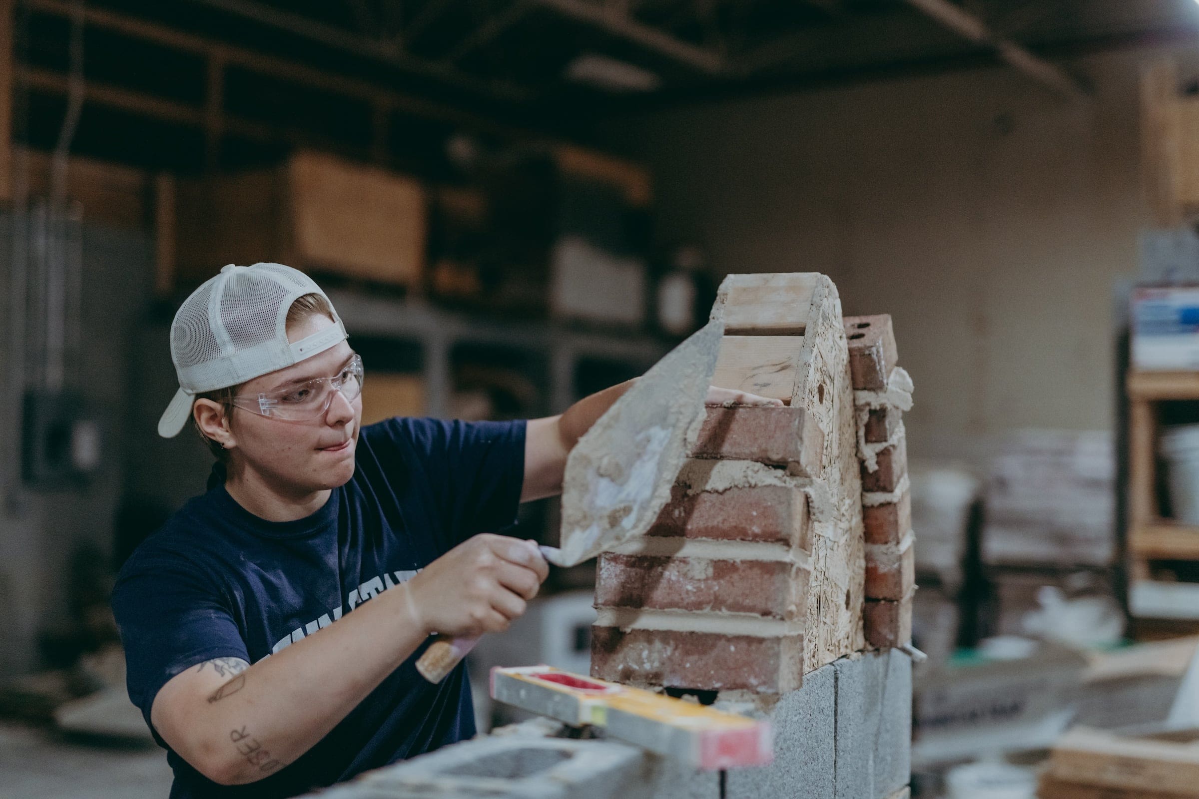 a student works on a technical piece of masonry.