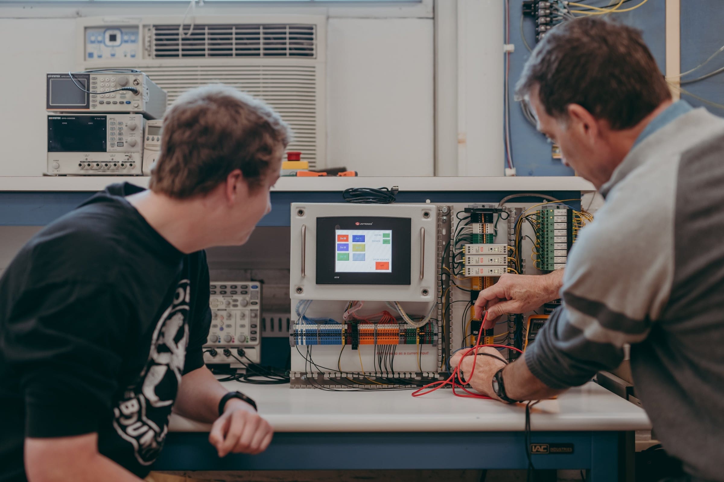 A faculty member and a student in the electronic engineering technology program investigate a challenge