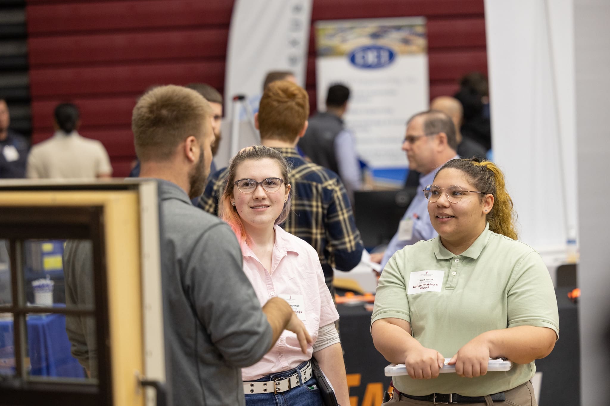 Students talking to an employer at a career fair