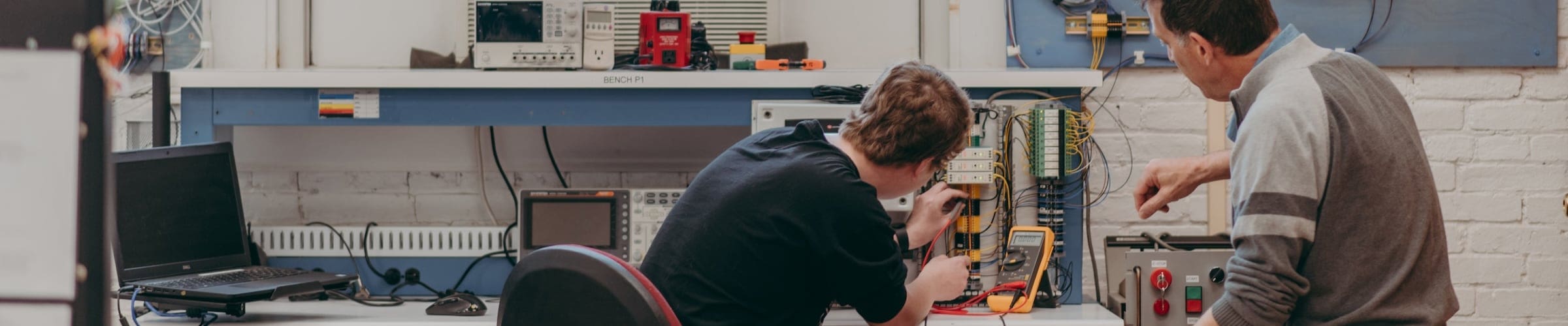 An instructor and student in the electronic engineering technology program work on a project