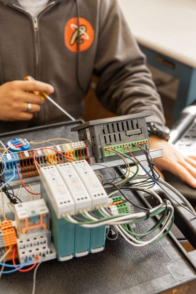 a student in the electronic engineering lab working with electronics.
